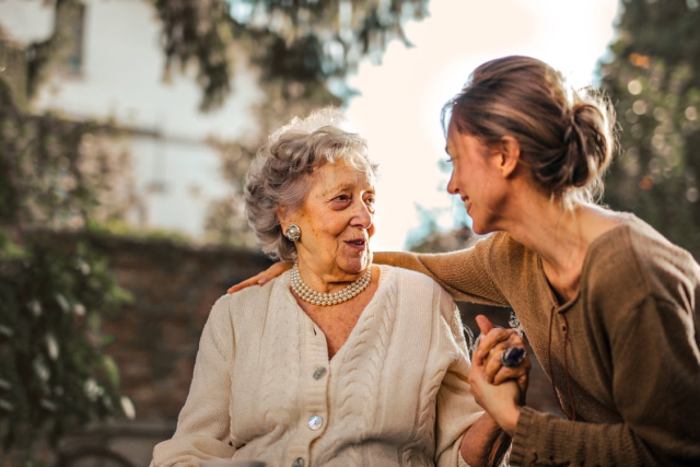a caregiver conversing with an elderly woman
