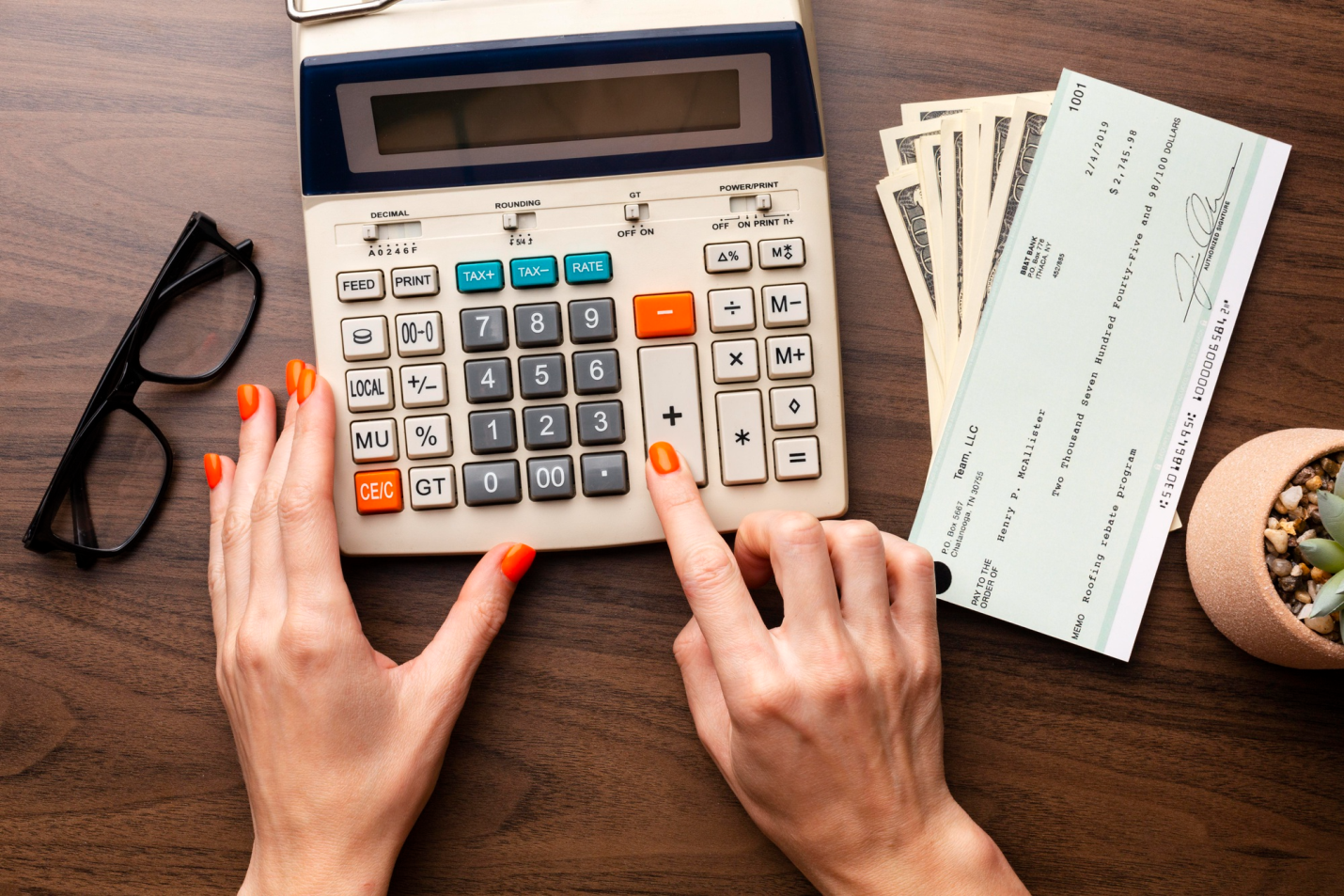 an overhead shot of a person using a calculator